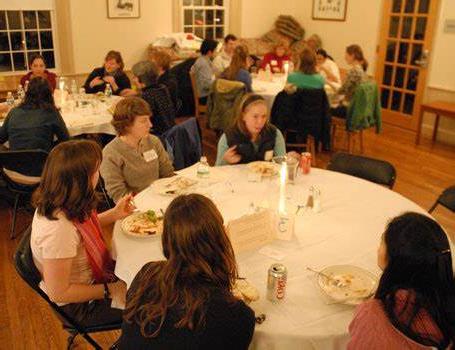 Five individuals talking around a table